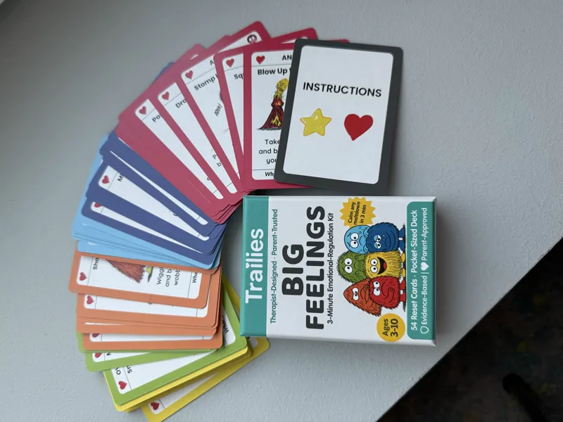 The Big Feelings Deck box with all 54 cards fanned in rainbow order