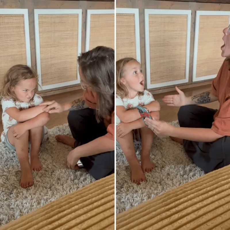 Two sisters doing a clapping-game reset together on the rug