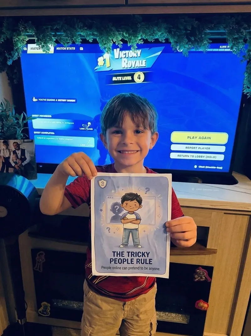 A boy holding the Tricky People Rule card in front of his game