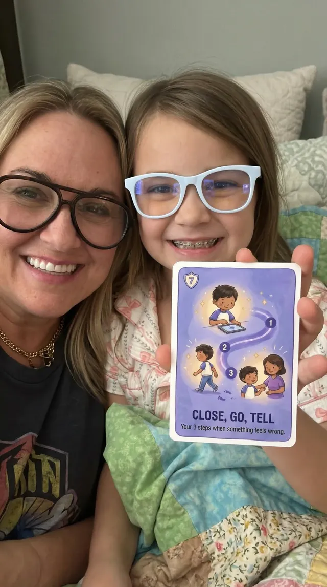 A mom and daughter holding up the Close, Go, Tell card