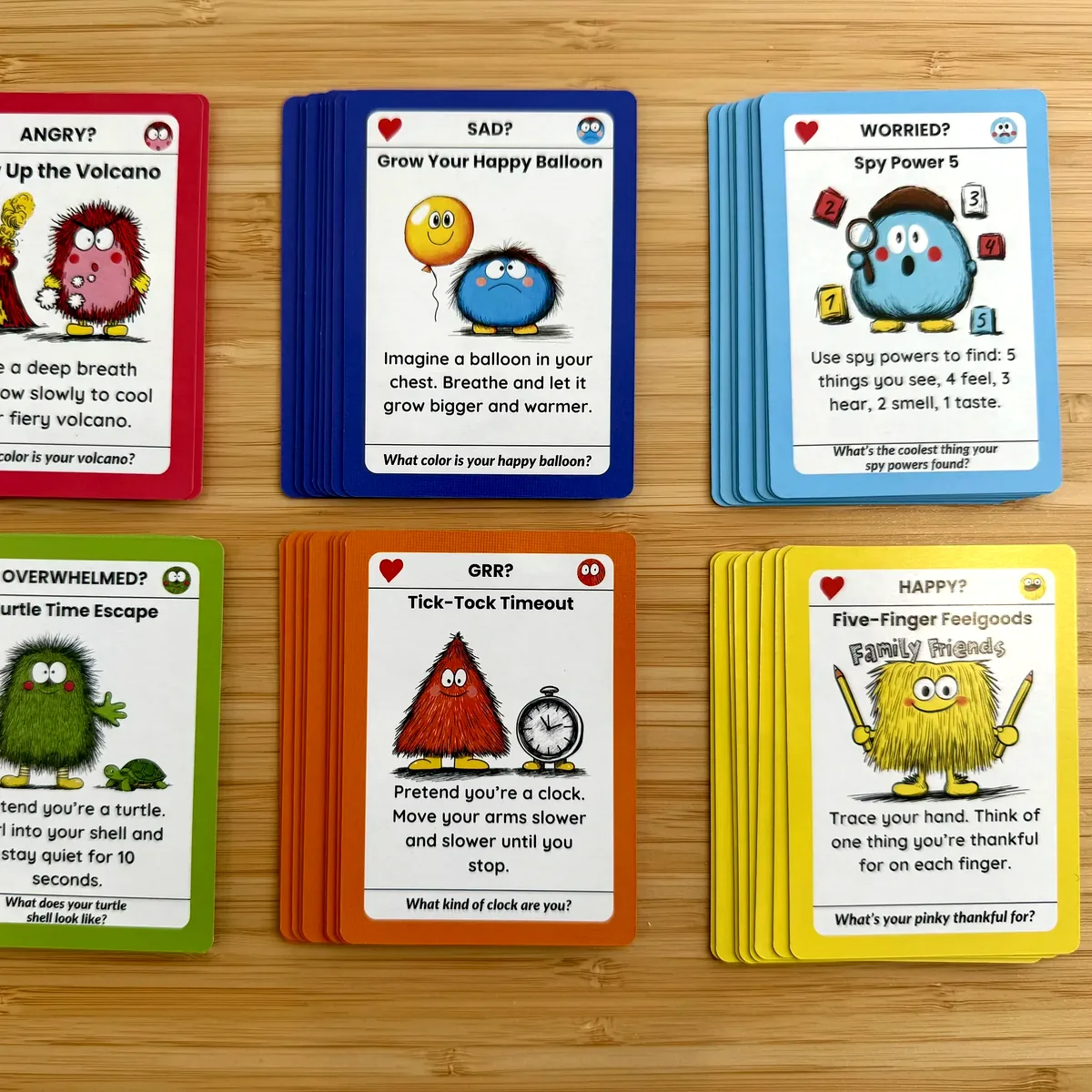 All six color-coded feeling piles of the Big Feelings Deck laid out on the table