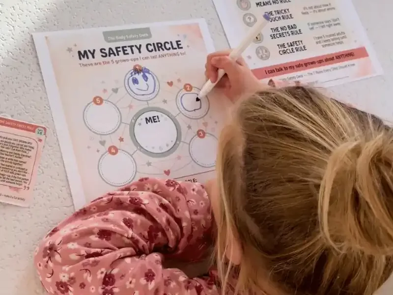 A young girl filling in her Safety Circle worksheet from the Body Safety Talk